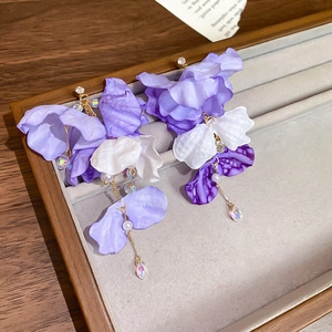 Detail of fabric flower earrings with purple gradient petals and crystal tassels