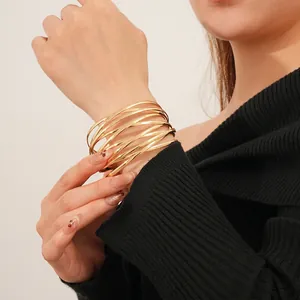 Chic multi-layer layered golden bangle bracelet featuring a minimalist crossover design for women
