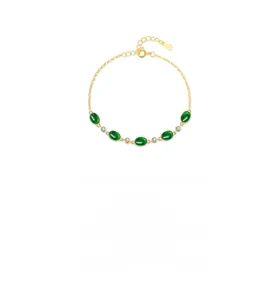 Detailed view of S925 silver bracelet featuring oval green gems and gold finish