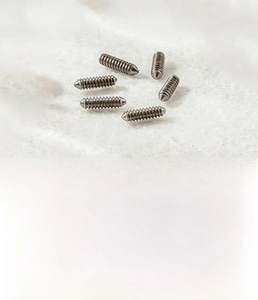 Detailed view of silver titanium steel screw threading for body jewelry accessories