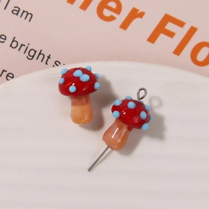 Detailed view of handmade glass mushroom charms for DIY earrings and hair accessories