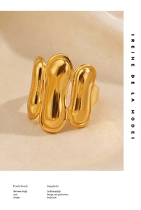 Detail of gold plated stainless steel ring with organic fluid geometric design