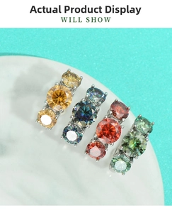 Detailed top view of four multi-colored moissanite rings on a white marble display tray