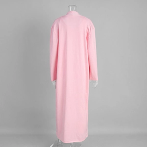 Detail view of the back of a light pink knitted long sleeve maxi dress set on a neutral base