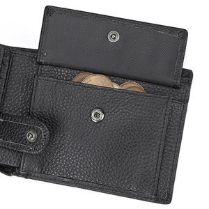 Detail of genuine leather wallet featuring a buttoned coin pocket with lychee texture