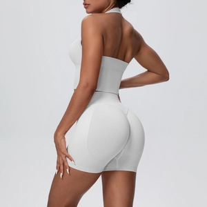 Rear view of white seamless yoga set featuring halter neck bra and scrunch butt shorts