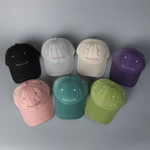 Macro view of multi-color plaid quick-dry baseball caps with Magical Secret embroidery