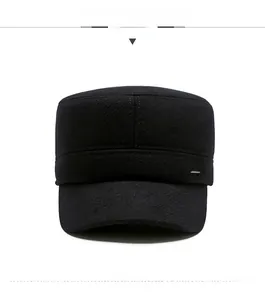 Detail of black wool flat top cap featuring side Sports metal badge and sturdy texture