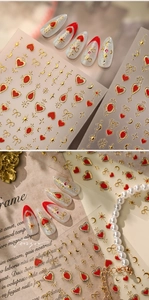 Macro detail of red and gold Y2K heart and star embossed 3D nail art stickers