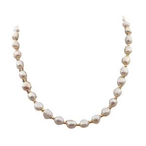 Baroque freshwater pearl necklace set with gold spacer beads on a white background