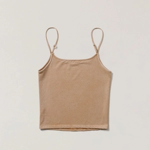 Detail of a vintage beige cotton camisole featuring thin straps and neat square neckline