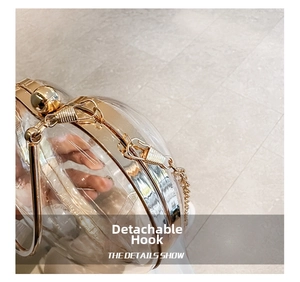 Detail view of the detachable gold chain hook on the acrylic heart-shaped clutch bag