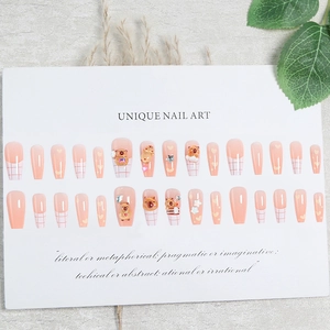 Sweet pink press-on nails with 3D cartoon bears, stars, and white plaid patterns
