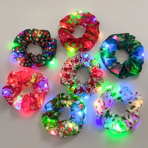 Set of 7 glowing LED Christmas hair scrunchies with Santa, elk, and tree patterns