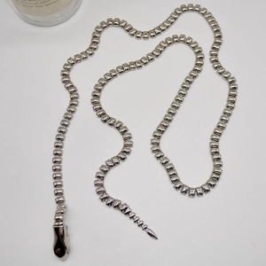 Detailed top view of a silver punk snake-head metal body chain with square links