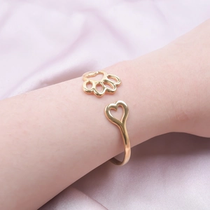 18k gold plated stainless steel open bangle featuring heart and cat paw charms