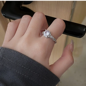 Close-up of elegant silver ring with a large zircon stone and wheat ear engraving