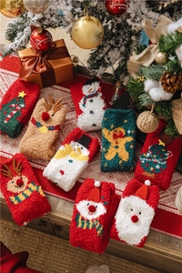 Detailed view of warm Christmas coral fleece socks featuring Santa and reindeer designs