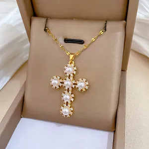 Elegant gold titanium steel cross necklace with pearls and crystals in a jewelry box