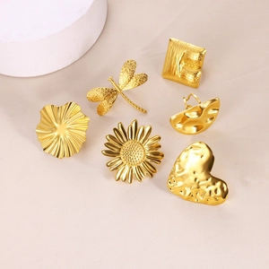 Collection of golden stainless steel rings with flower, heart and hammered texture designs