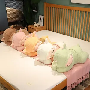 Group of sleeping lamb plush toys in colorful sweaters arranged on a cozy bed
