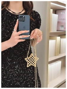 Star-shaped golden beaded handbag with metallic mesh texture and delicate chain strap