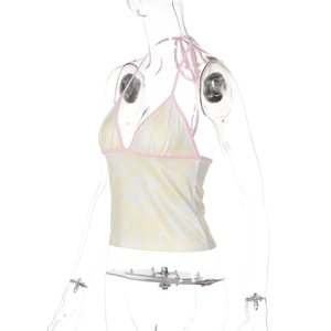 Detailed view of the pink trim and floral print on this yellow halter neck crop top