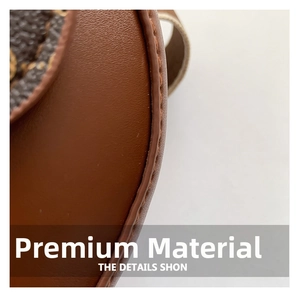 Macro detail of brown leather saddle bag featuring fine yellow stitching and monogram pattern