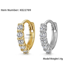 Macro shot of 6mm mini hoop earrings in gold and silver finish with sparkling zircons