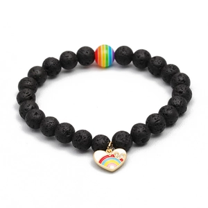 Black lava rock beaded bracelet with rainbow stripe bead and heart enamel charm on white background