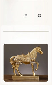 Close-up of a golden resin horse statue with inlaid blue and yellow gemstones on a pedestal