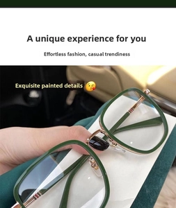 Detail of dark green square glasses frames featuring metallic hinges and striped temple tips