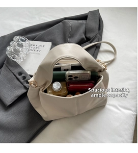 Detail view of cream leather tote bag interior showing large capacity and lychee texture