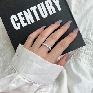Close-up of S925 sterling silver ring with alternating rectangular and round cubic zirconia
