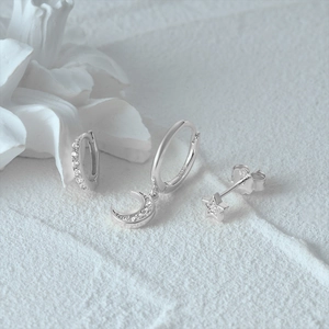 Detail of 925 sterling silver moon and star earrings set with cubic zirconia stones