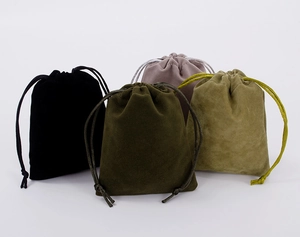 Detail of four velvet drawstring jewelry pouches in black, olive, brown and khaki