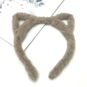 Macro detail of plush cat ear headband with soft taupe faux fur texture and fabric finish