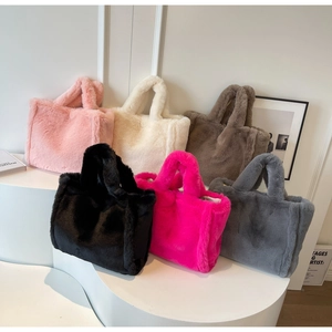 Detail view of colorful faux fur tote bags collection in minimalist interior display