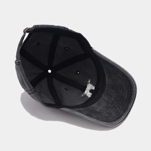 Detail showing inner structure of washed cotton baseball cap with adjustable metal buckle