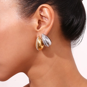 Detail of tear-drop earrings in gold and silver plating with micro-pave zircons
