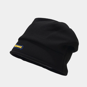 Detailed macro view of black waffle knit beanie texture and Garment rectangular side patch