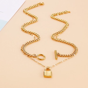 Gold double-layered necklace featuring a chunky Cuban chain with OT clasp and padlock pendant