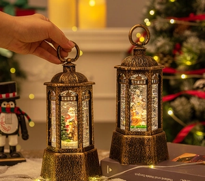 Close-up of vintage bronze Christmas lantern with Santa scene and warm LED glowing light