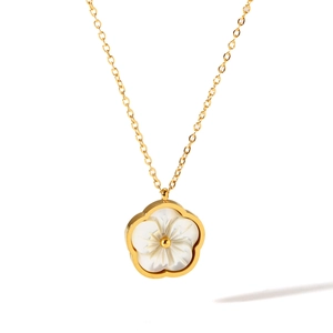 Detail of gold chain necklace featuring a white shell plum blossom flower pendant