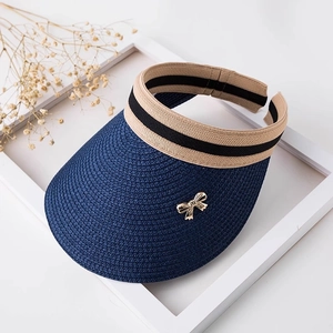 Navy blue straw sun visor with wide brim, striped headband and gold bow metal buckle