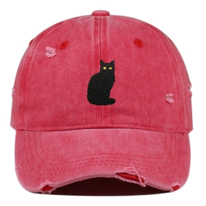 Detail view of distressed cotton baseball cap with embroidered black cat pattern