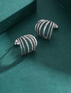 Macro shot of S925 sterling silver multilayer stud earrings with pavé set crystals