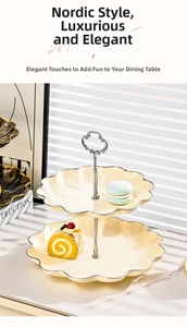 Detail of a 2-tier ceramic dessert stand with silver metal handle and wavy petal edges
