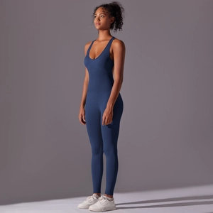 Side view of deep blue seamless yoga jumpsuit showing ergonomic fit and racerback detail