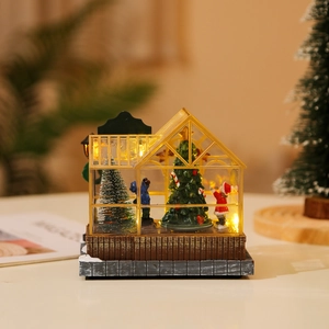 Detail of glowing Christmas village house featuring Santa and snowman with warm LED lights